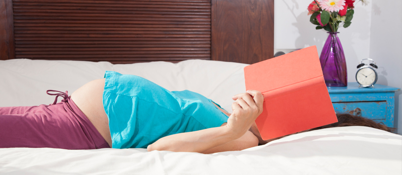 Woman Reading Prenatal Book